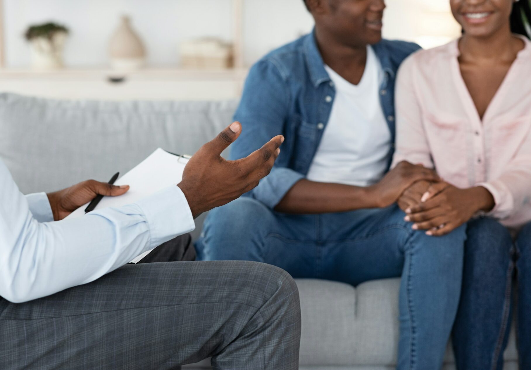 Marriage Counseling. Unrecognizable Black Counselor Talking To Happy Black Couple At Office